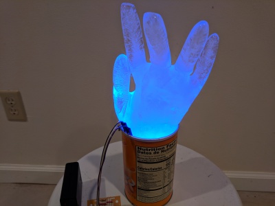 WS2812 LED buried in an ice hand glowing blue.