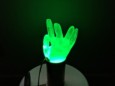 WS2812 LED buried in an ice hand glowing green.