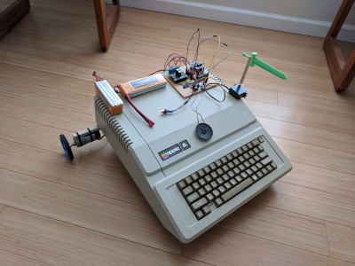 Apple IIe with batteries and motor control board on top.