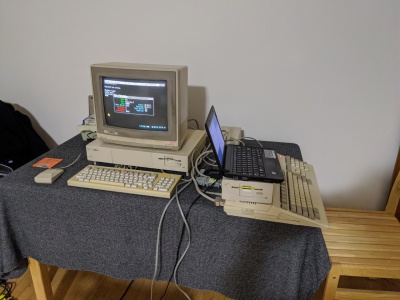 Amiga 500 connected with a serial cable to a PC.