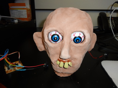 Clay head electronic artwork with moving eyeballs